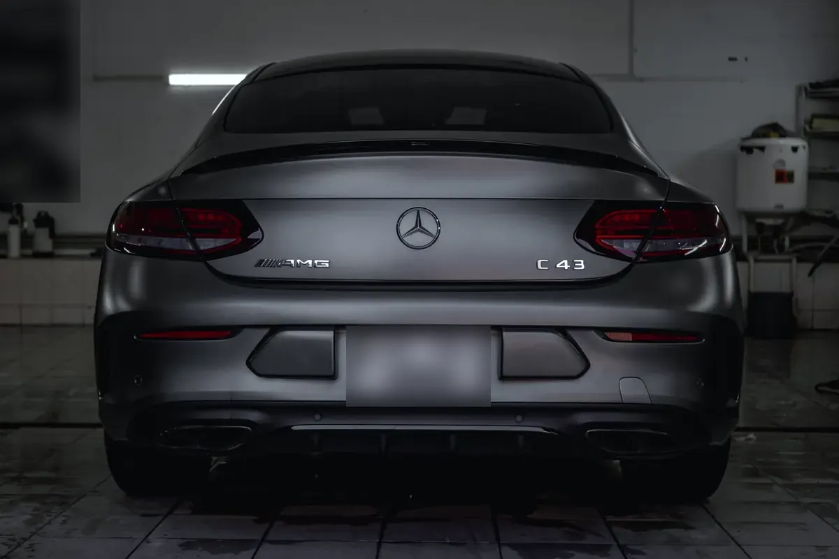 Rear view of a grey Mercedes-AMG C 43 coupe inside a workshop
